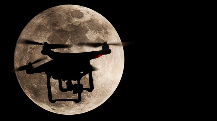 Silhouette of a drone against the moon 