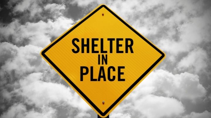 Street sign stating "Shelter in Place"