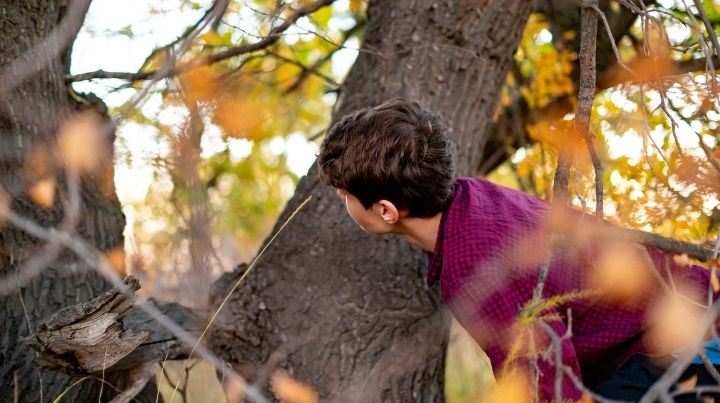 Boy hiding in the woods at rally point