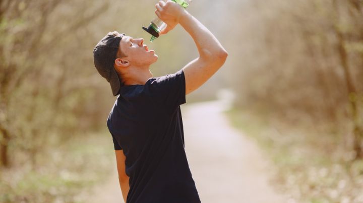 Man drinking water in woods