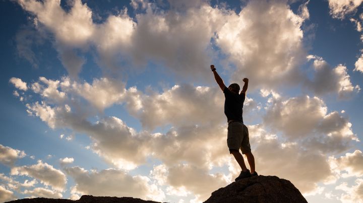 Person standing on top of mountain