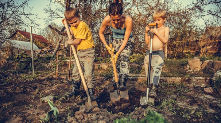 A mother and children gardening. 