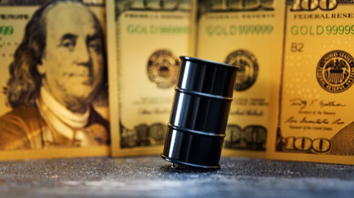 Oil barrel positioned in front of a hundred dollar bill