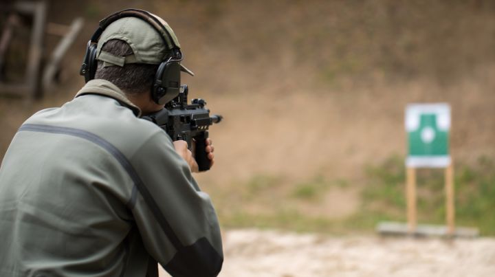 Person shooting carbine at target