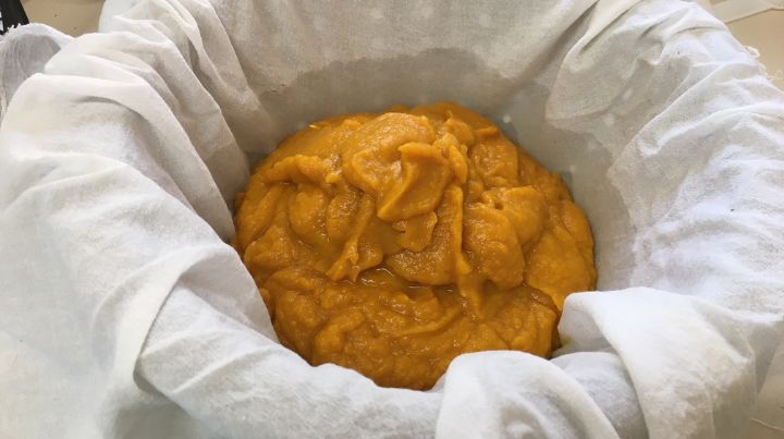 Put the pumpkin meat into a colander lined with cheesecloth