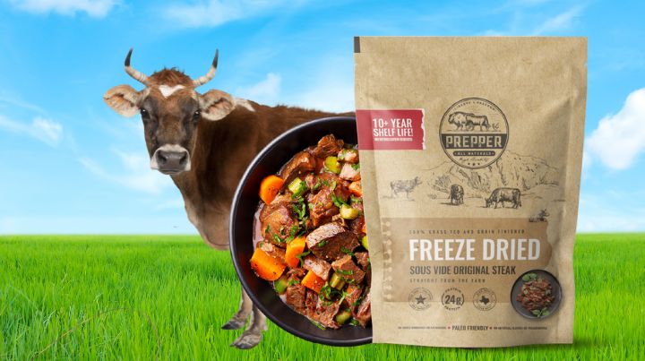 A cow with a package of PrepperBeef.com's freeze dried beef