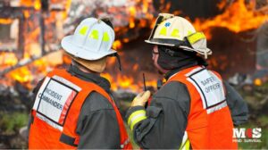 Firefighters looking at a home that is on fire