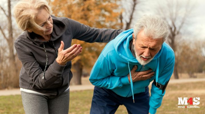 A woman helping a man suffering from a heart attack