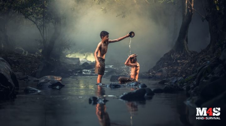 Kids washing in a creek. 