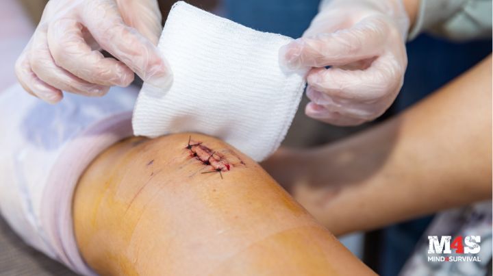 A person dressing a leg wound