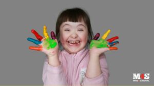 A cute special needs girl with painted fingers.
