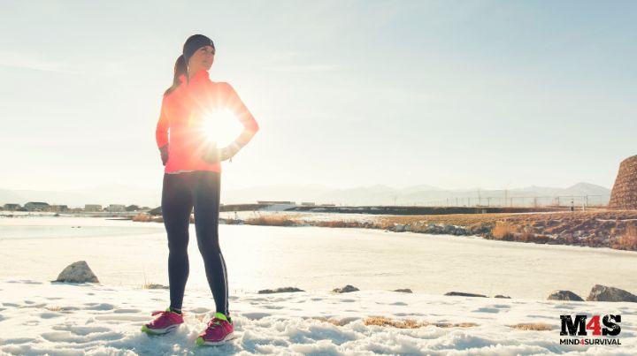 Confident woman standing in snow