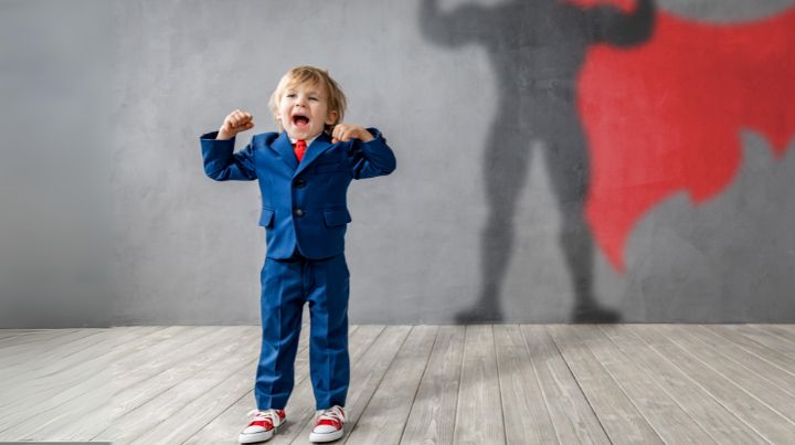 Excited child with shadow of superman